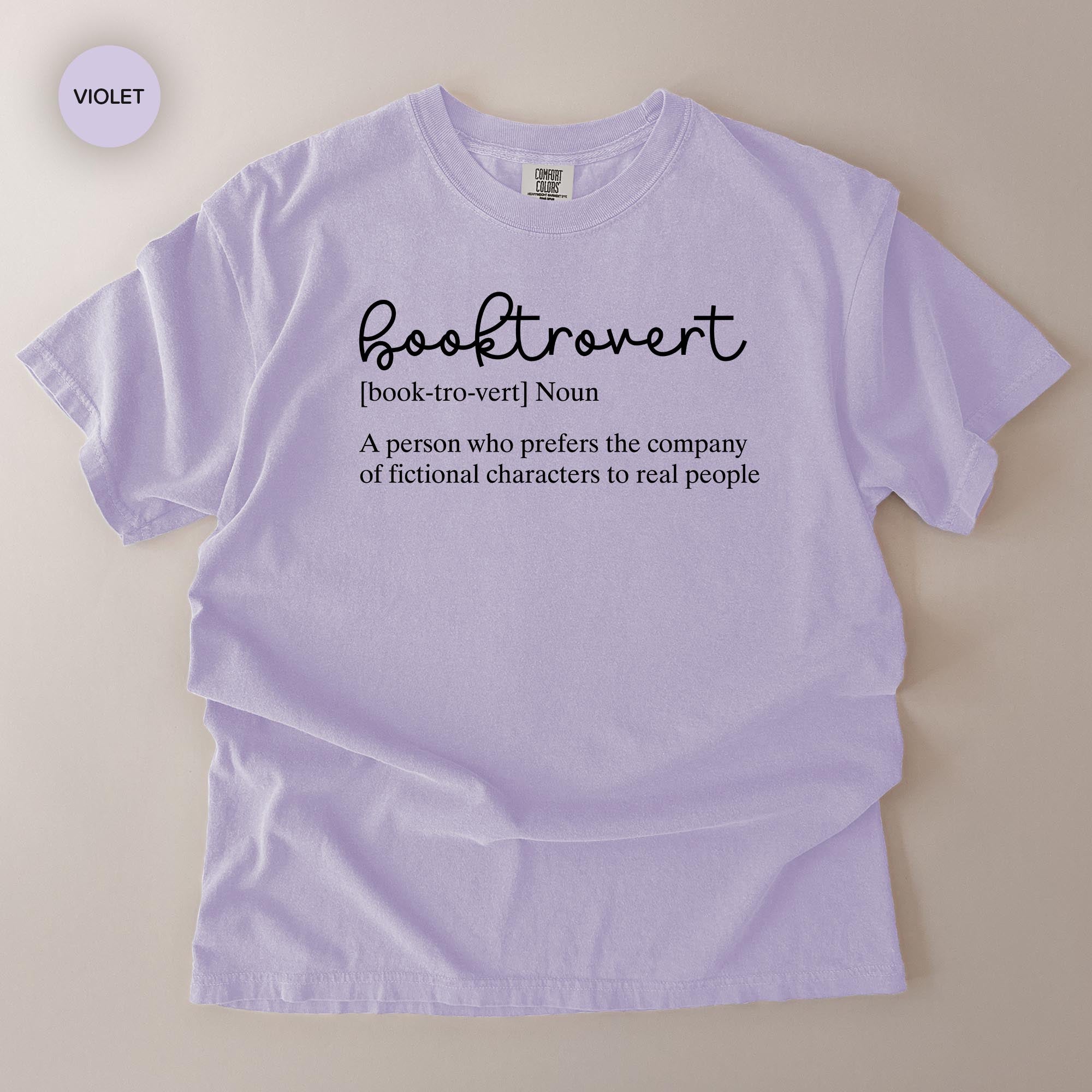 A purple t-shirt with the definition of a book-free person printed on it.