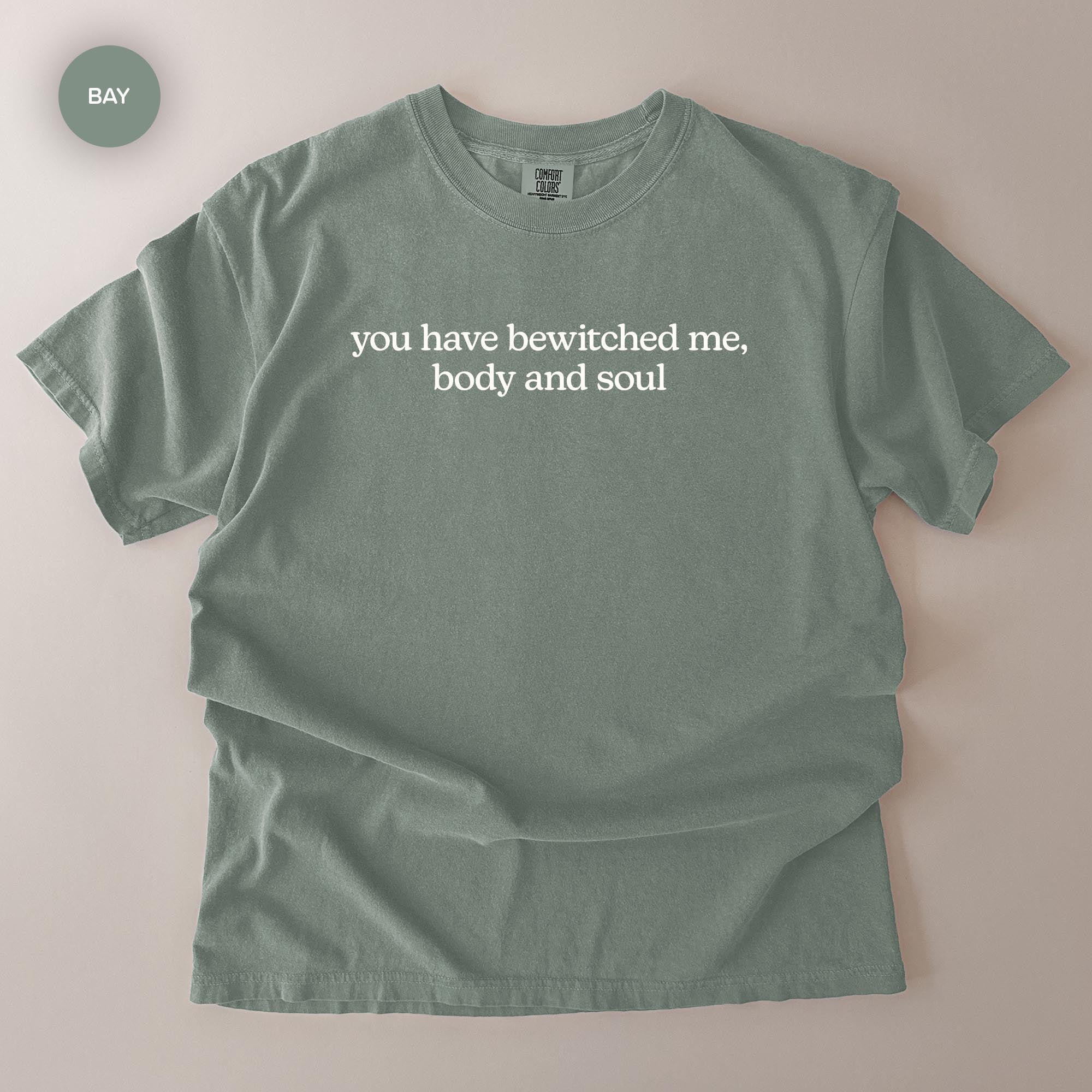 A gray t-shirt with the text "you have witchced me, body and soul" printed on it.