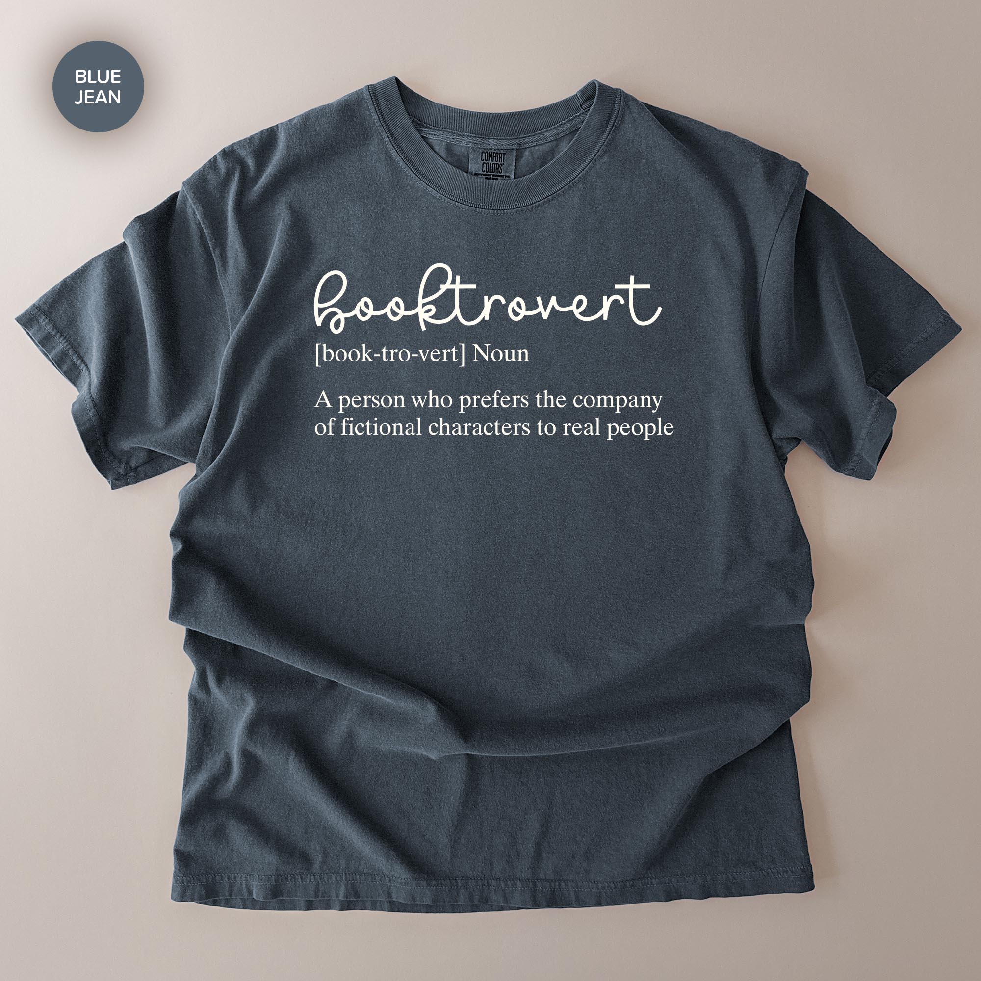 A gray t-shirt with the definition of a book-hoarder printed on it.