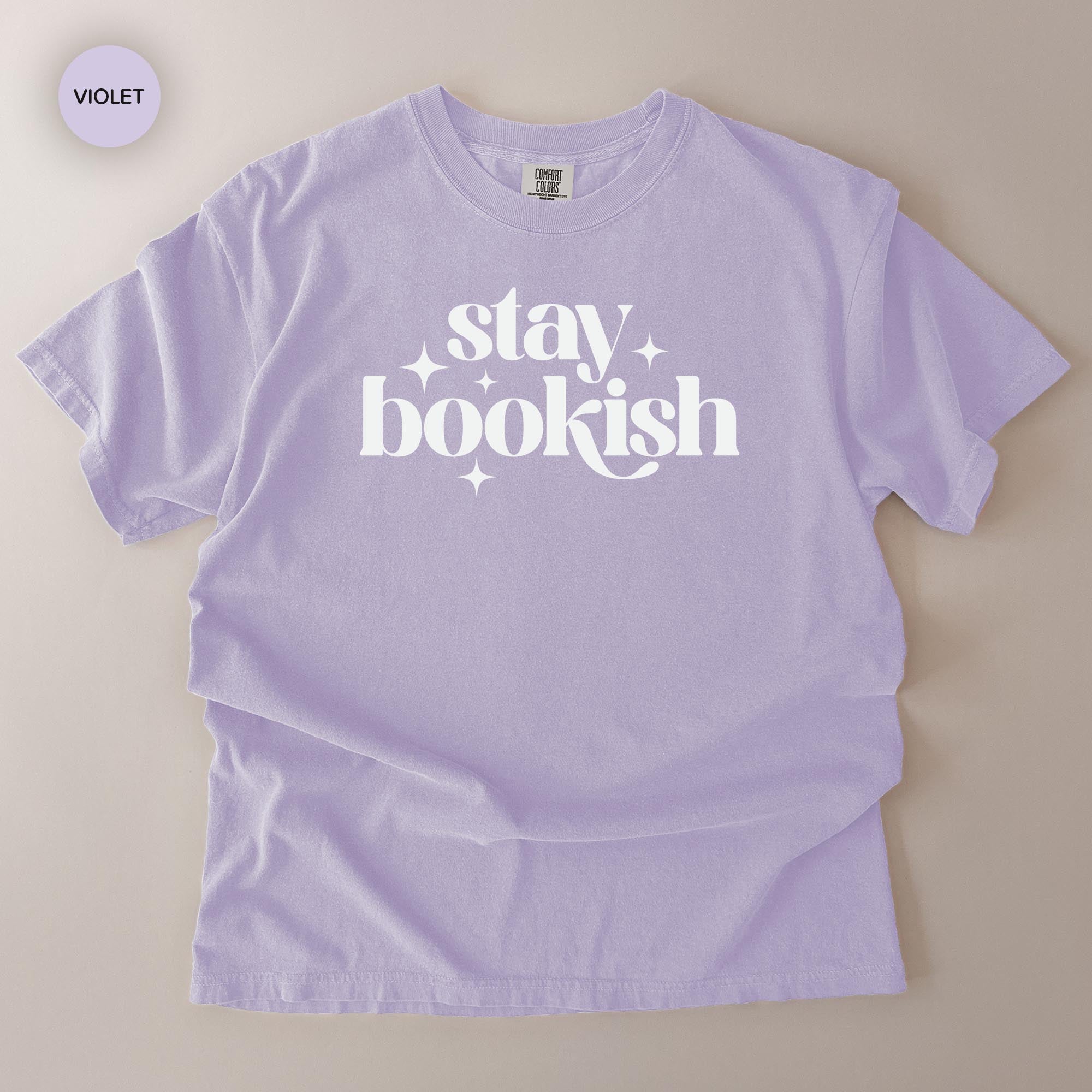 A purple t-shirt with the text "stay bookish" printed on it.