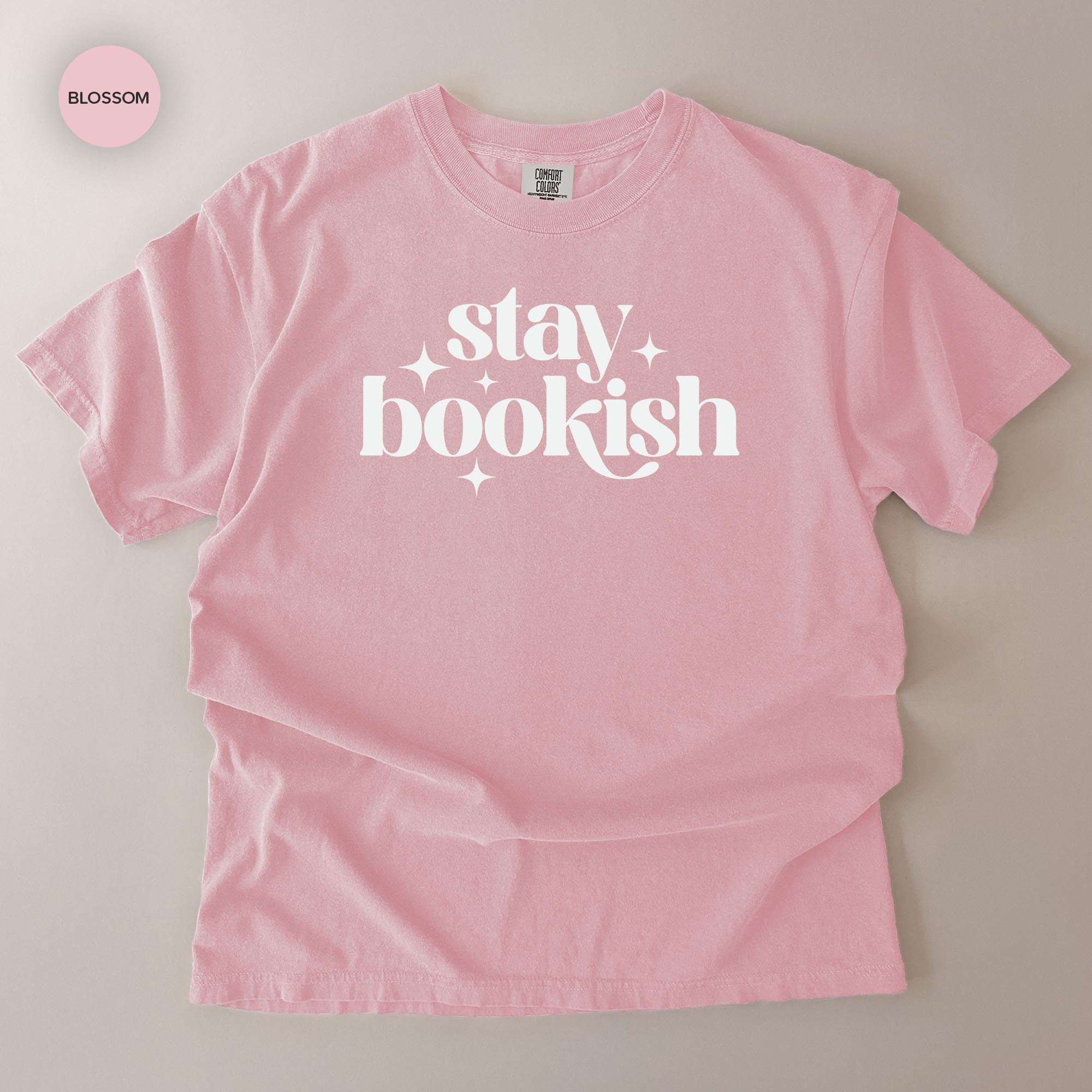 A pink t-shirt with the text "stay bookish" printed on it.