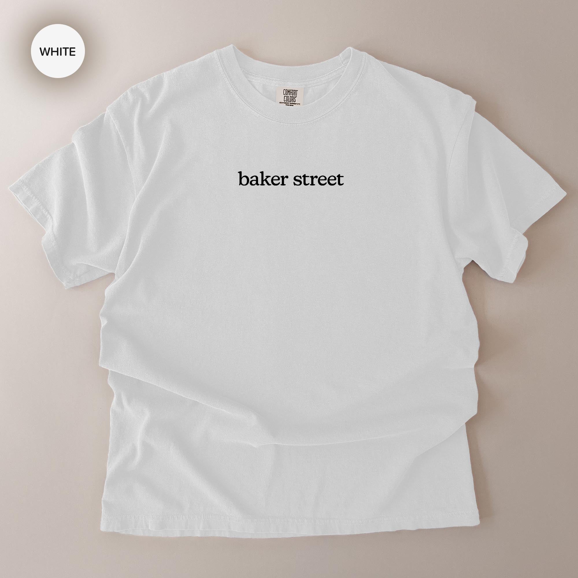 A white t-shirt with the text "baker street" printed on it.