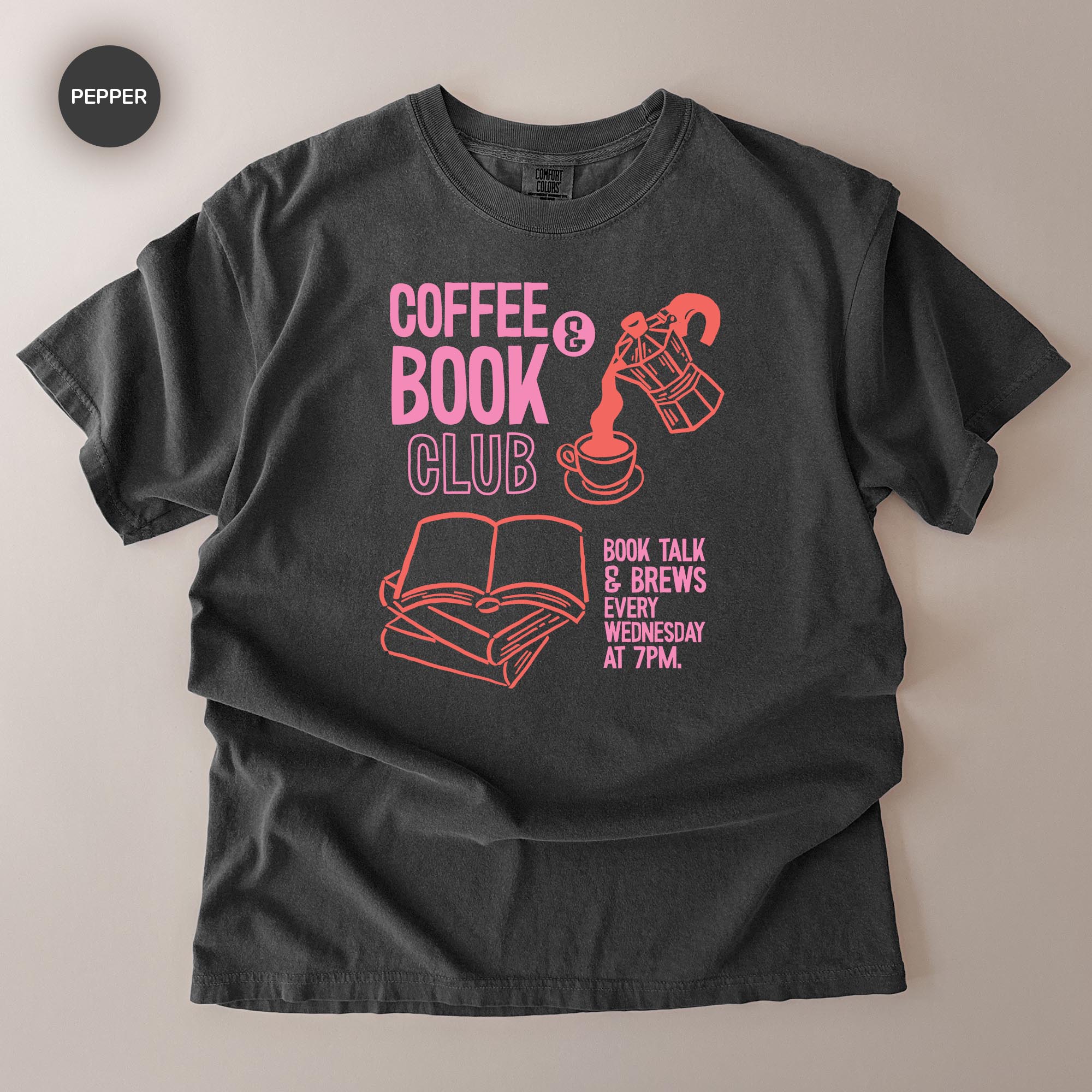 A black t-shirt with a graphic design featuring a coffee cup, a book, and text promoting a book club event.