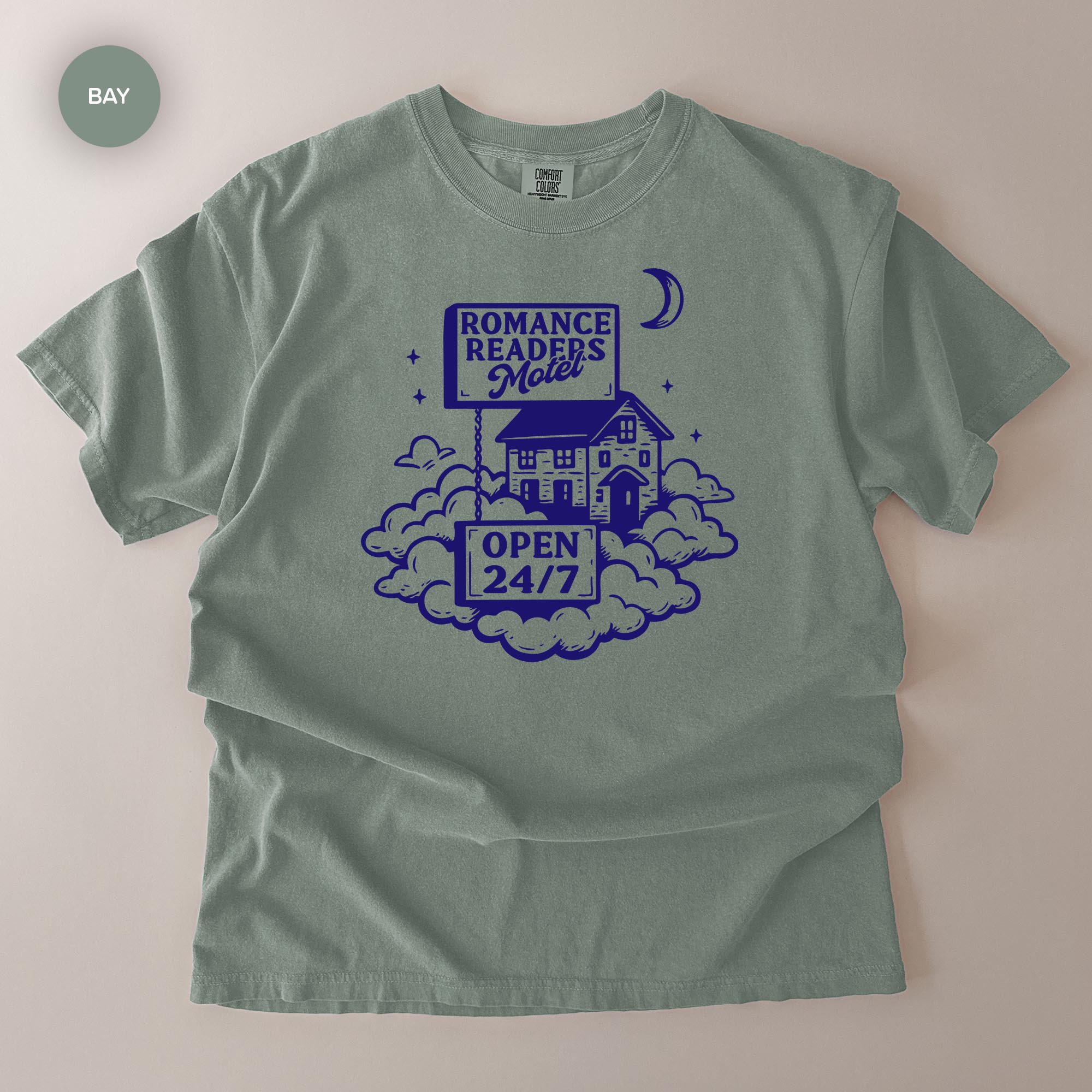 A gray t-shirt with a graphic design featuring a motel and a crescent moon.
