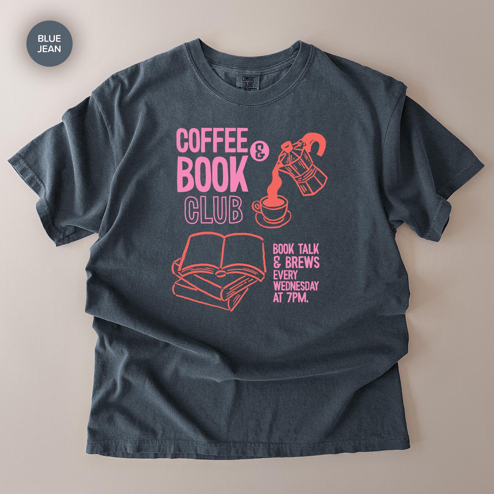 A gray t-shirt with a graphic design featuring a coffee cup, a book, and text promoting a book club event.