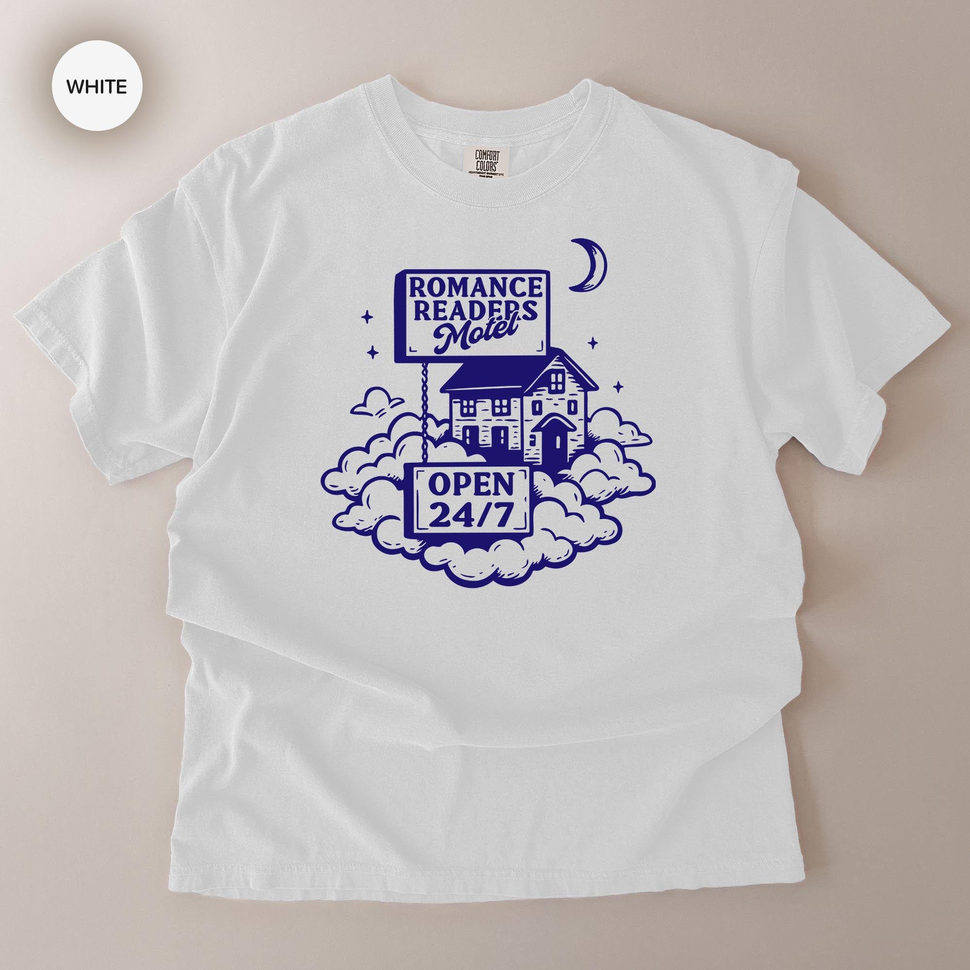 A white t-shirt with a graphic design featuring a motel and a crescent moon.