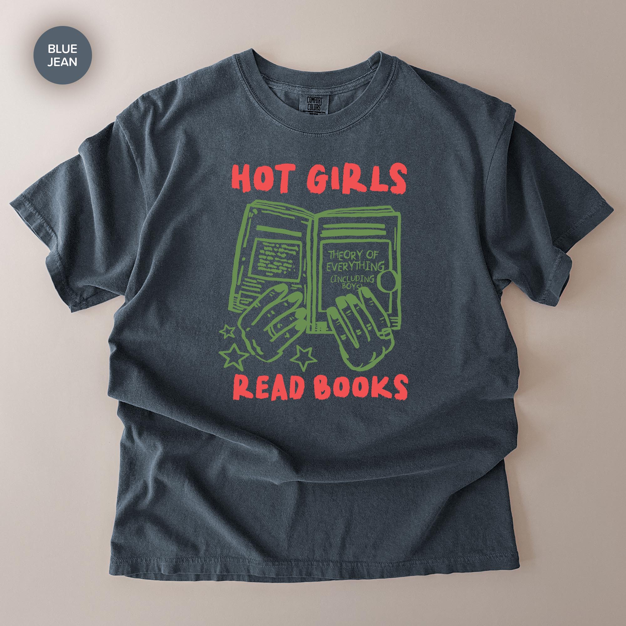 A gray t-shirt with a graphic design featuring a pair of hands holding open a book, with the text "HOT GIRLS READ BOOKS" printed on it.