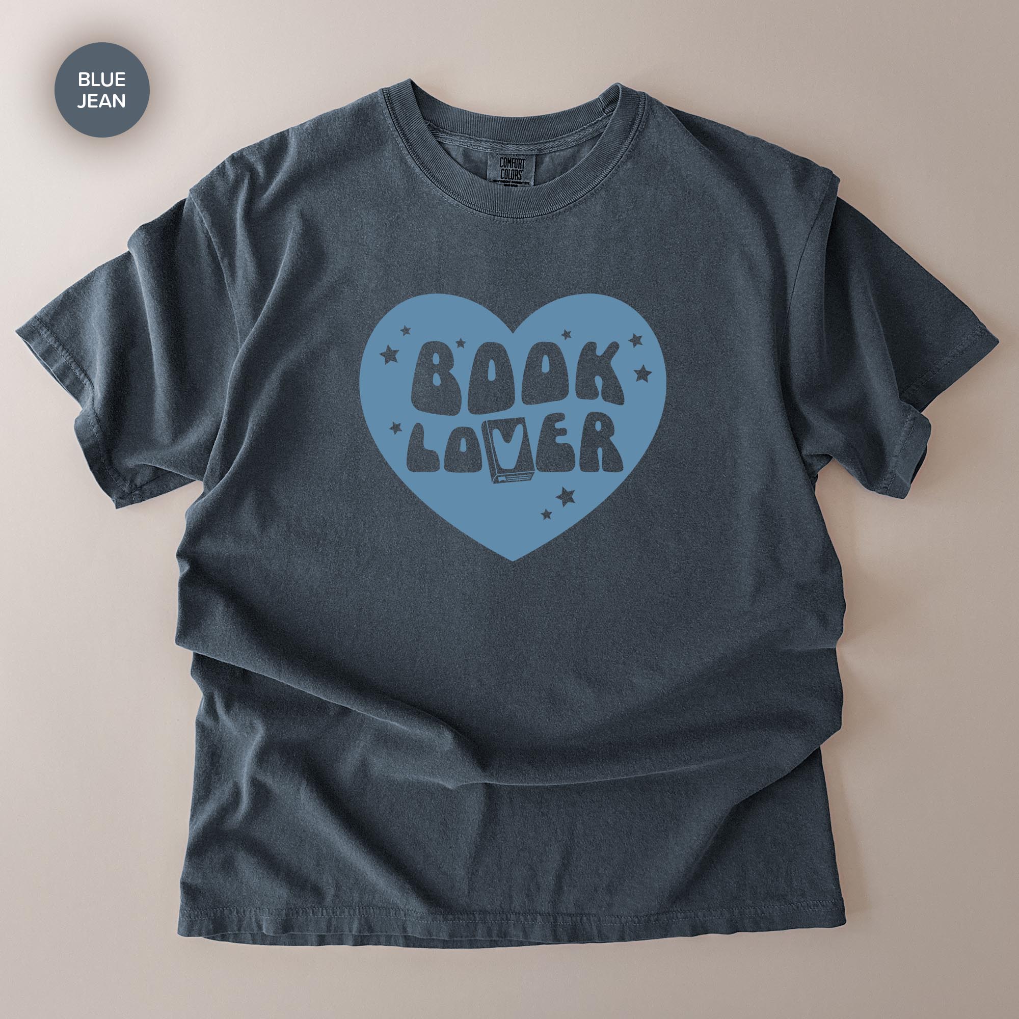 A gray t-shirt with a blue heart-shaped graphic and the text "BOOK LOVER" printed on it.