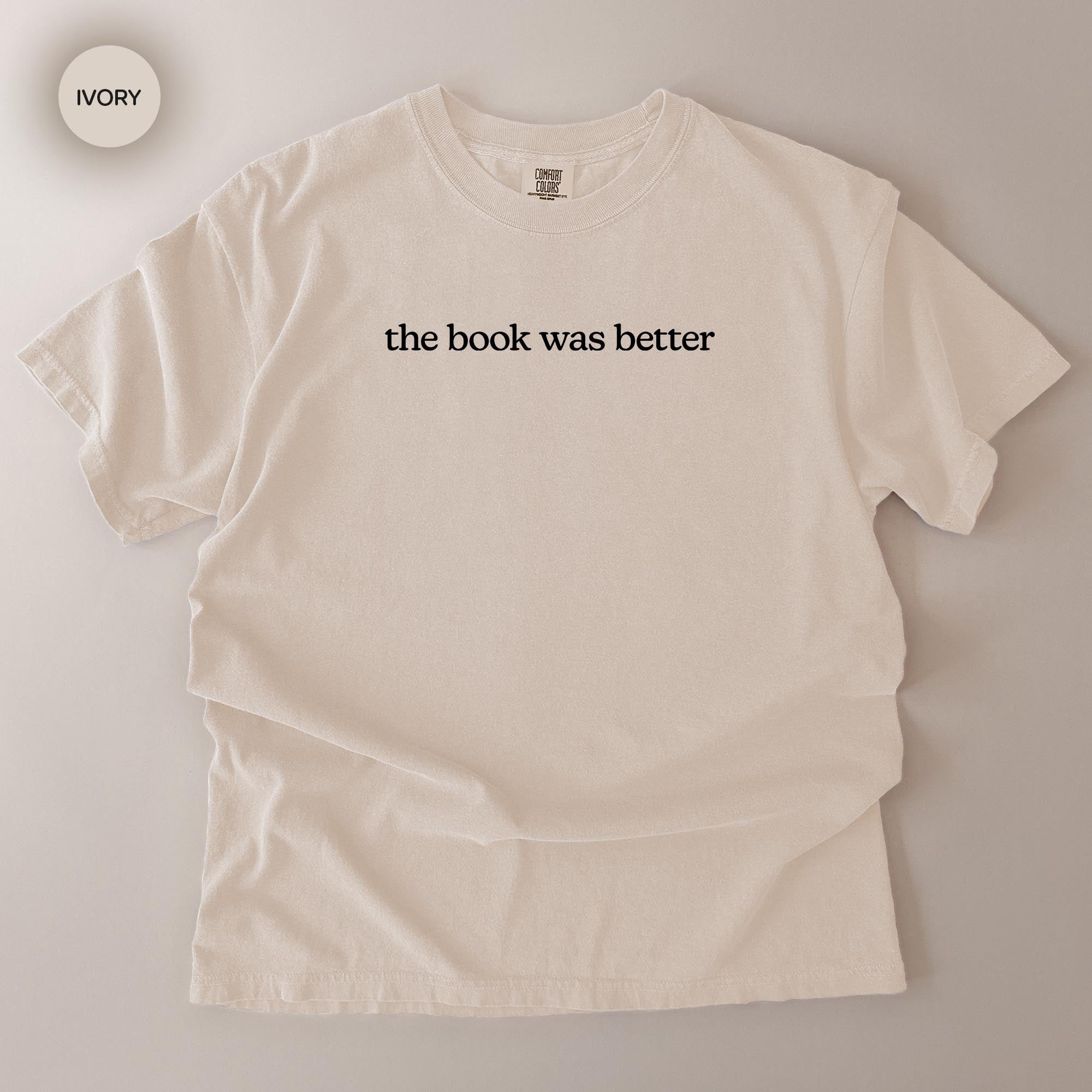 A white t-shirt with the text "the book was better" printed on it.