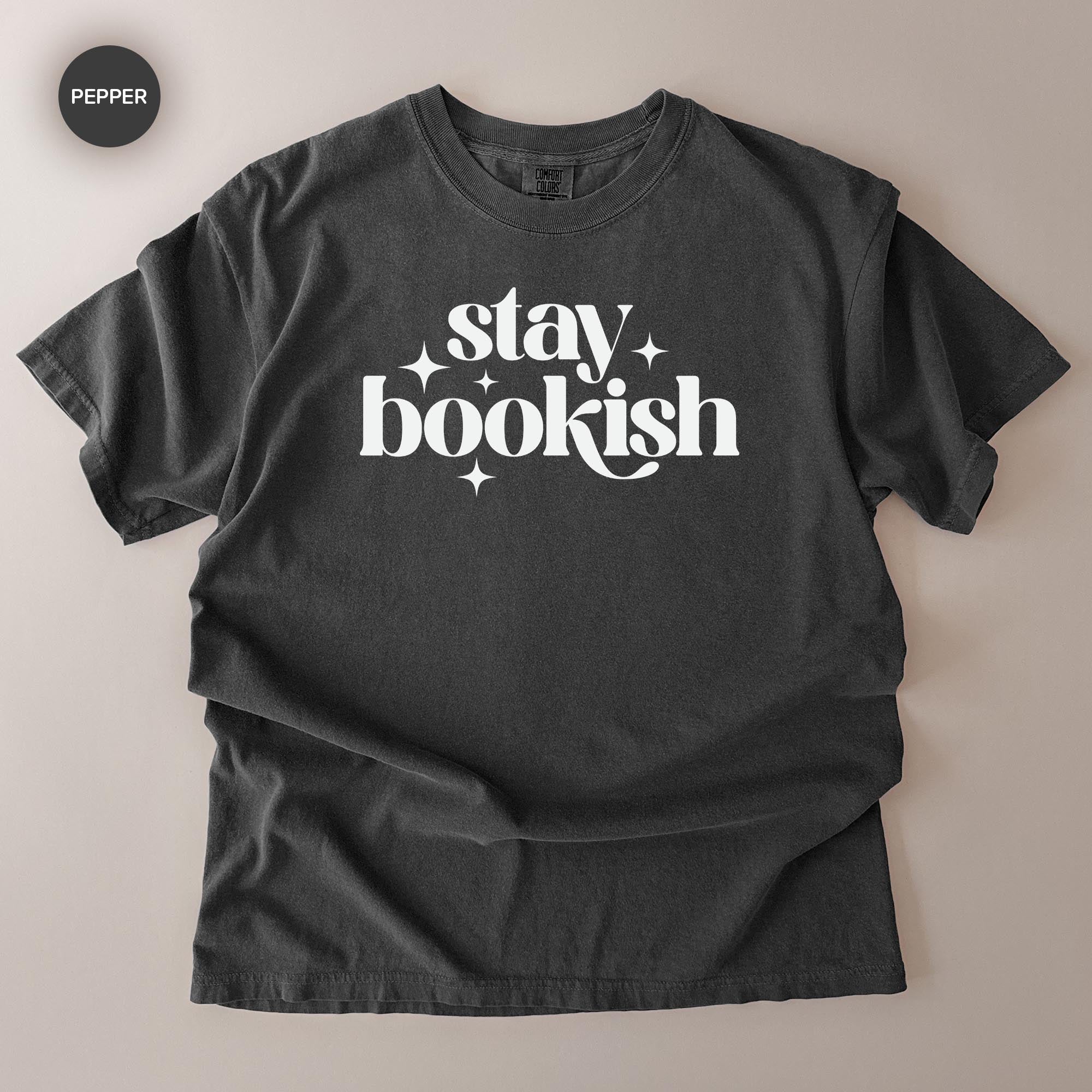 A black t-shirt with white text that says "stay bookish" printed on it.