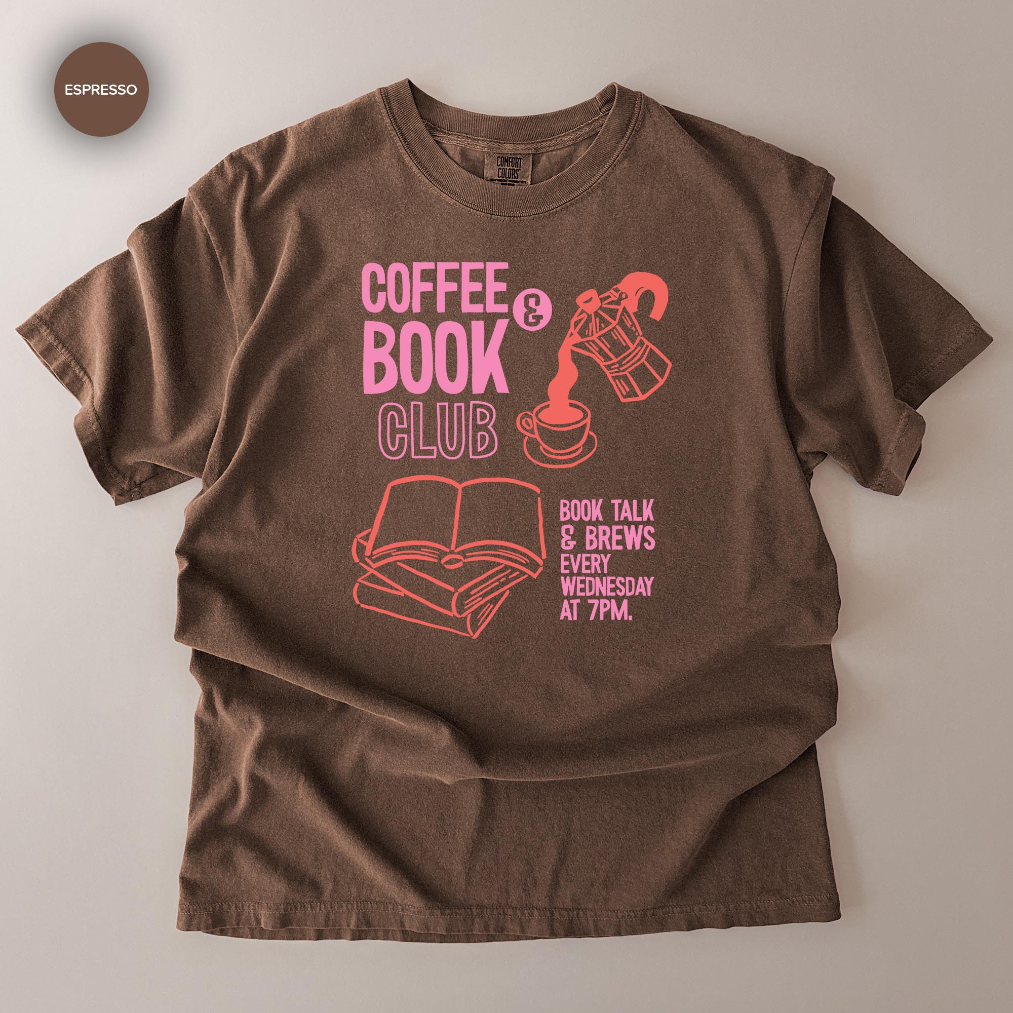 A brown t-shirt with a graphic design featuring a coffee cup, a book, and a coffee pot, along with text promoting a book club event.