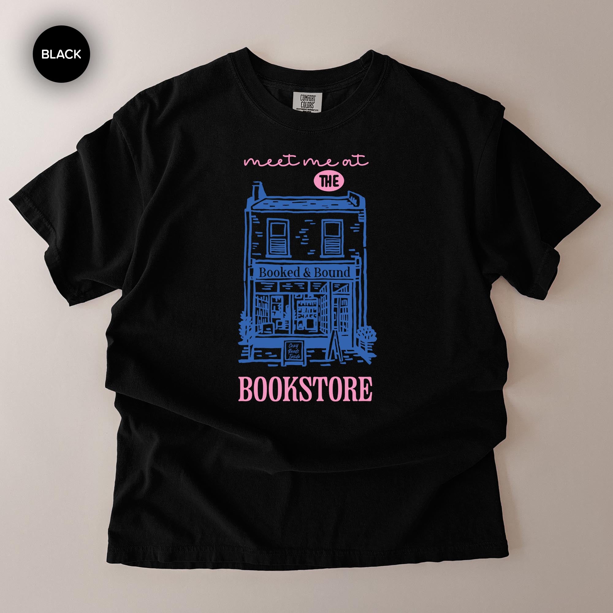 A black t-shirt with a graphic design depicting a building and the text "Bookstore" printed on it.