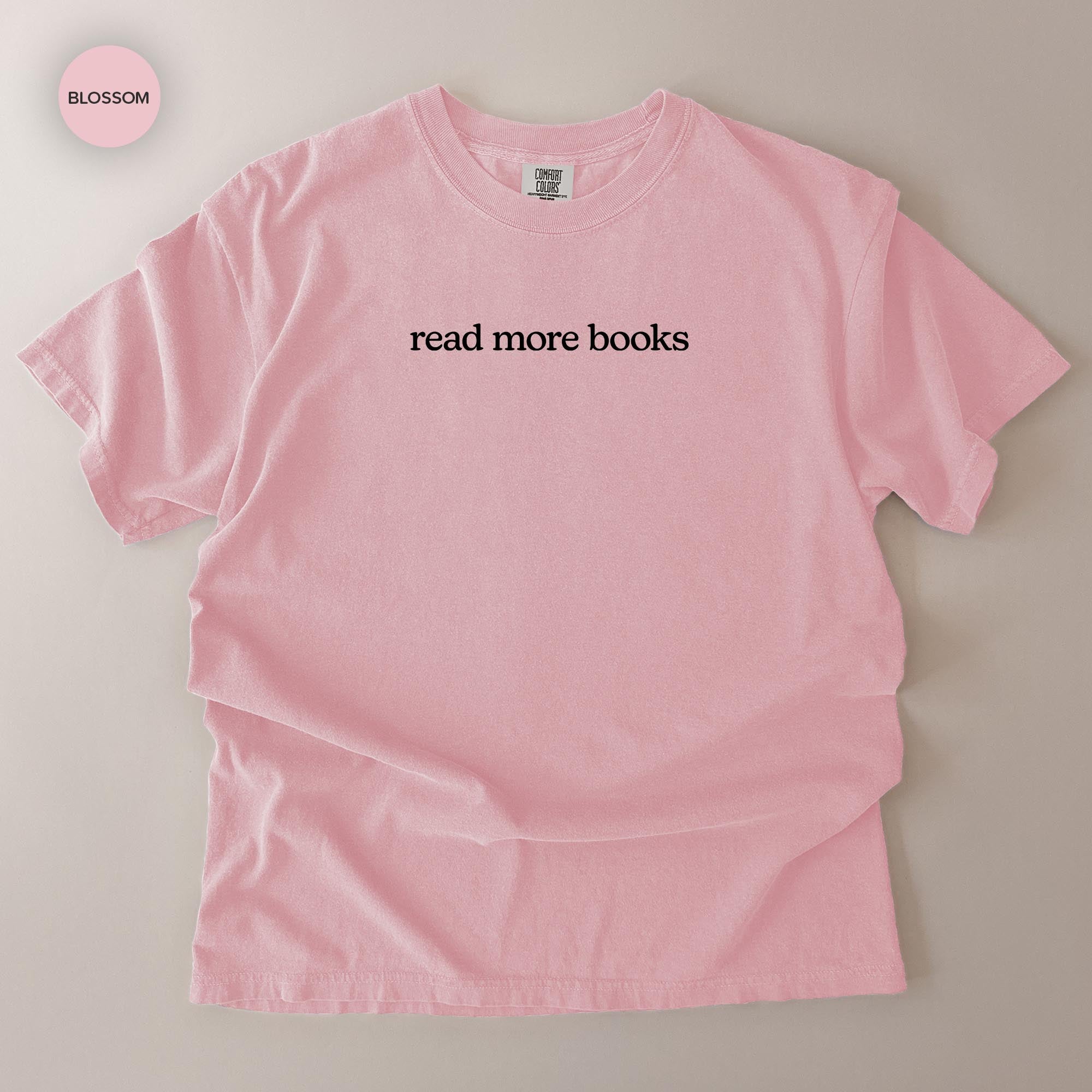 A pink t-shirt with the text "read more books" printed on it.