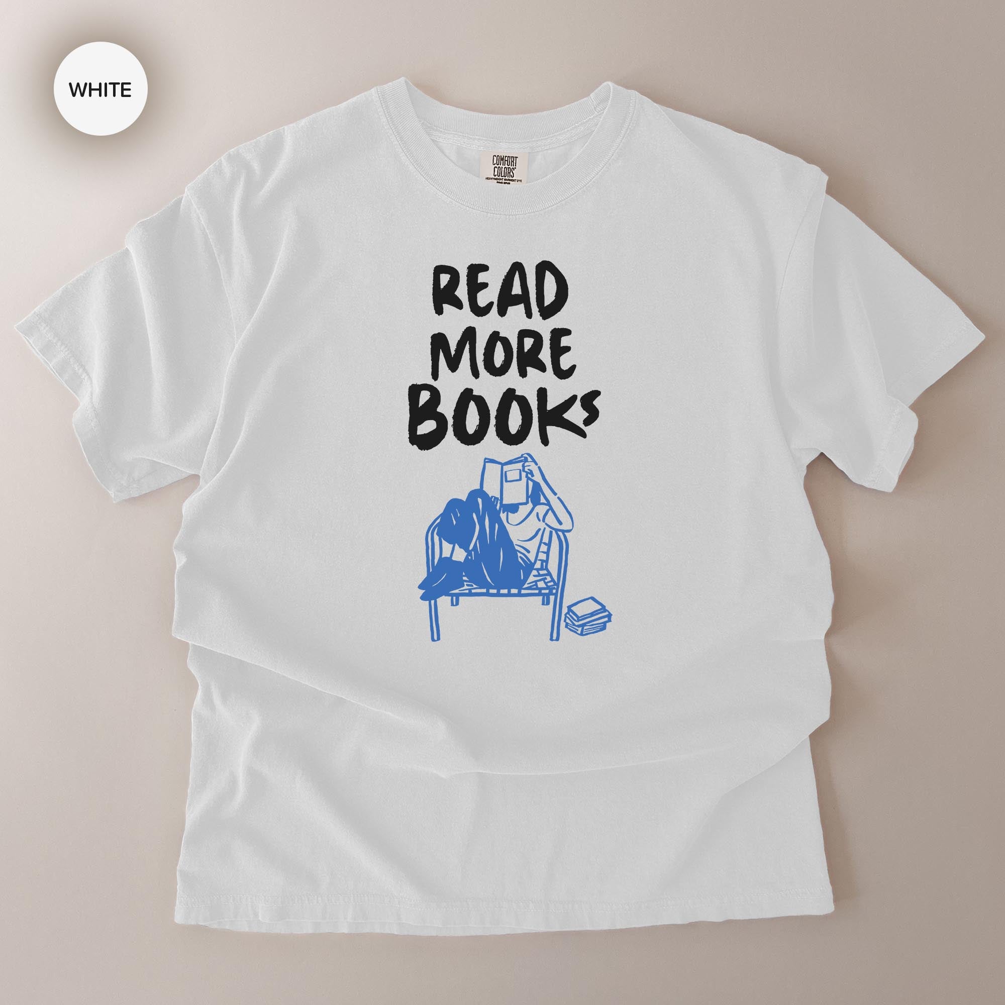 A white t-shirt with the text "READ MORE BOOKS" printed on it.