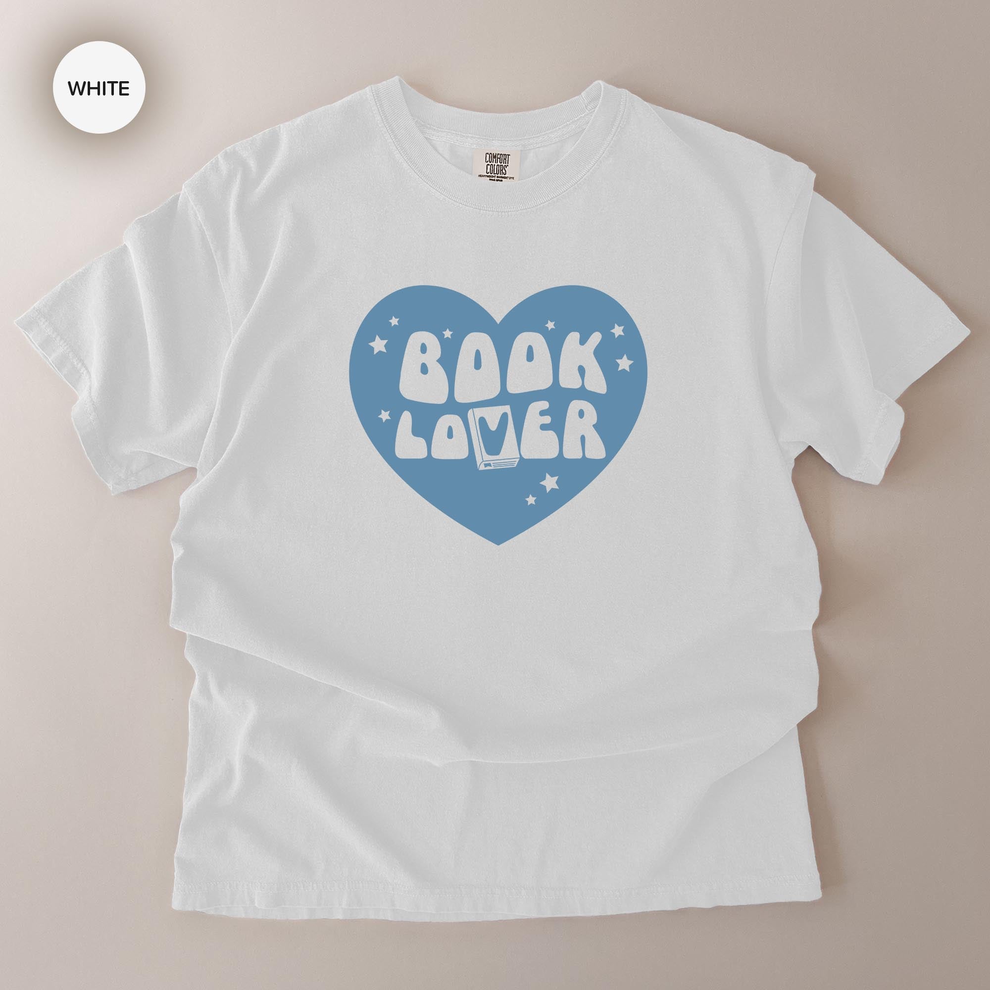 A white t-shirt with a blue heart-shaped graphic and the text "BOOK LOVER" printed on it.
