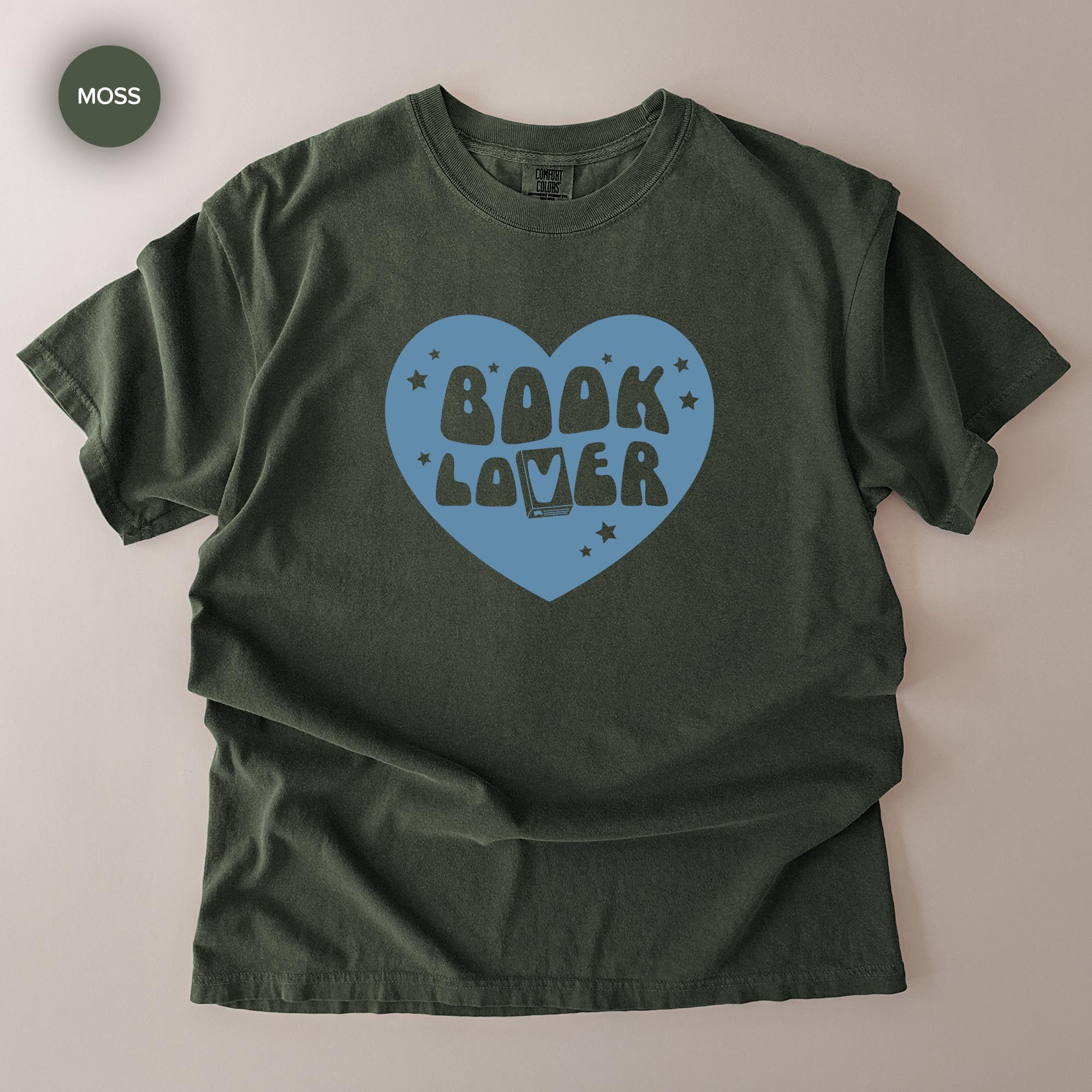 A green t-shirt with a heart-shaped graphic and the text "BOOK LOVER" printed on it.
