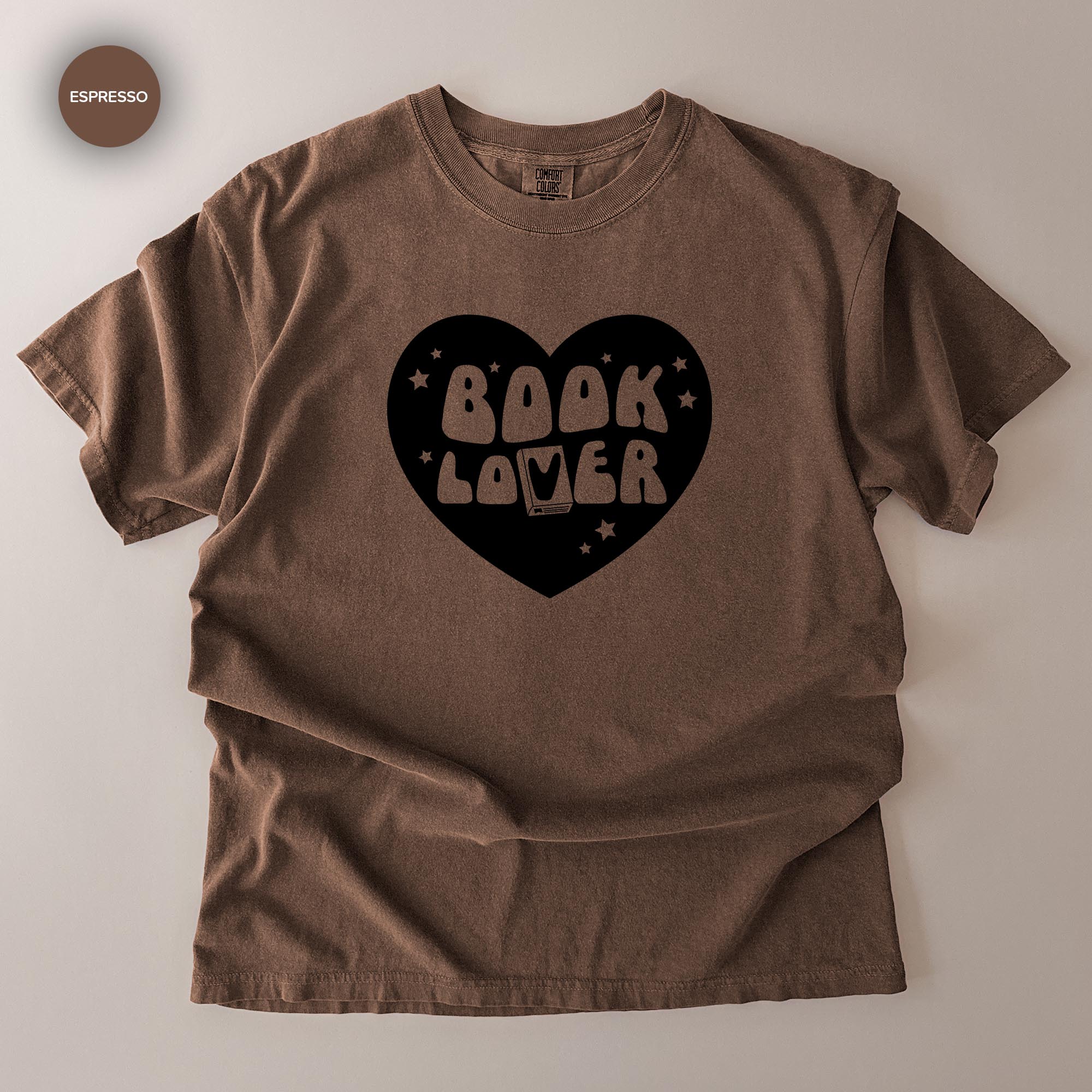 A brown t-shirt with a heart-shaped graphic and the text "BOOK LOVER" printed on it.