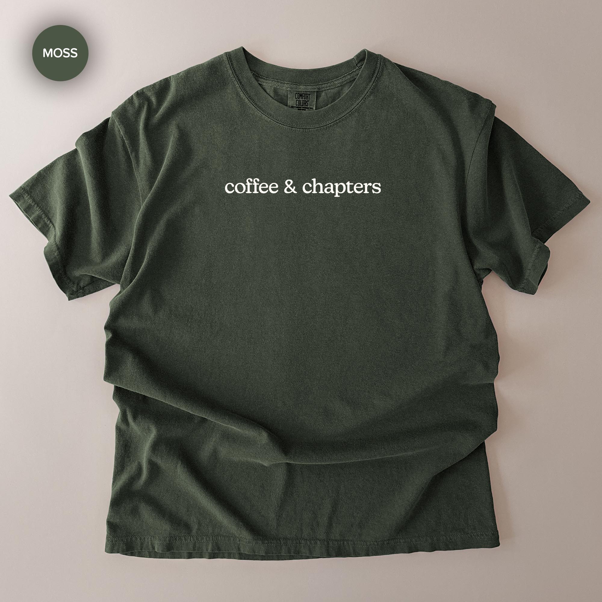A dark green t-shirt with the text "coffee & chapters" printed on it.