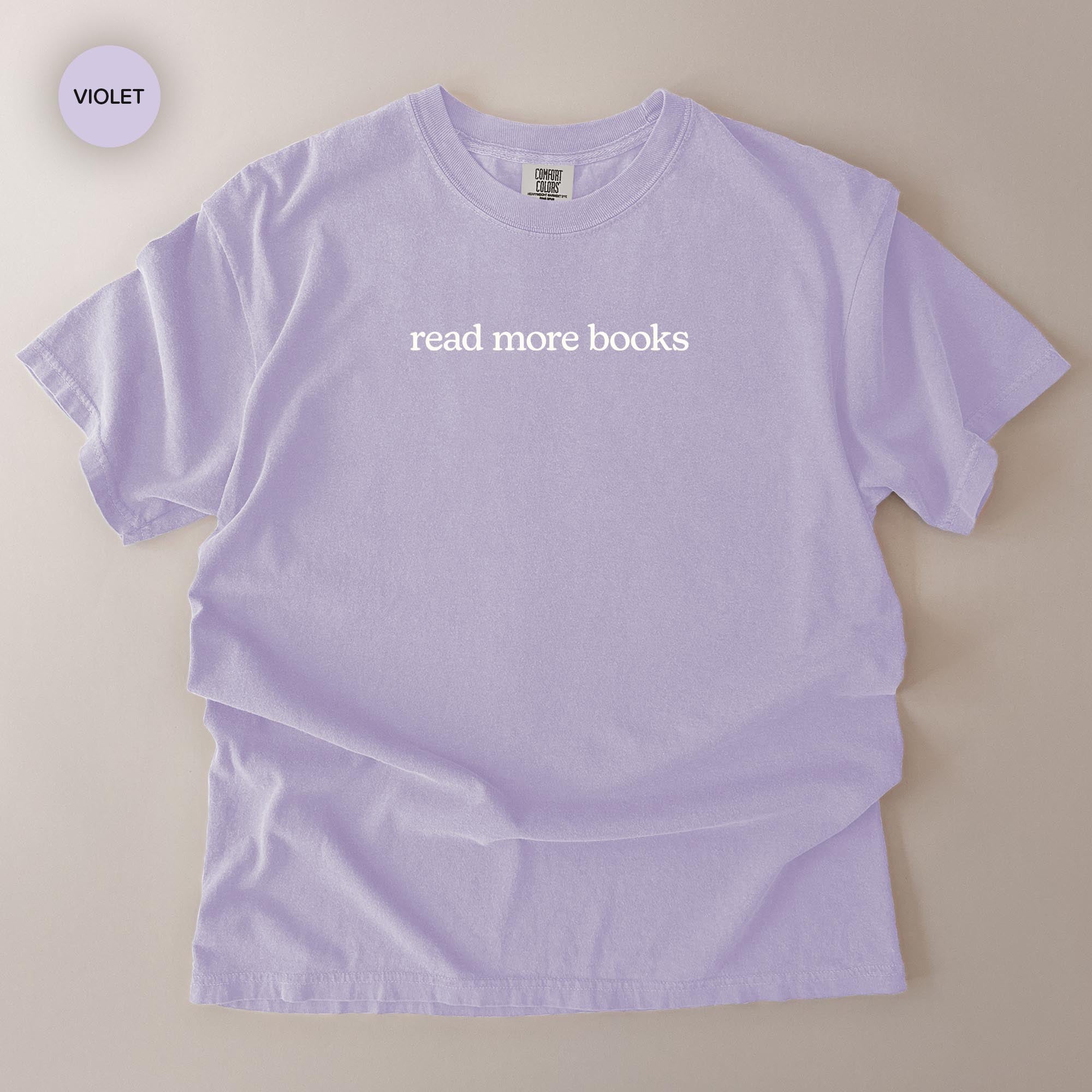 A light purple t-shirt with the text "read more books" printed on it.