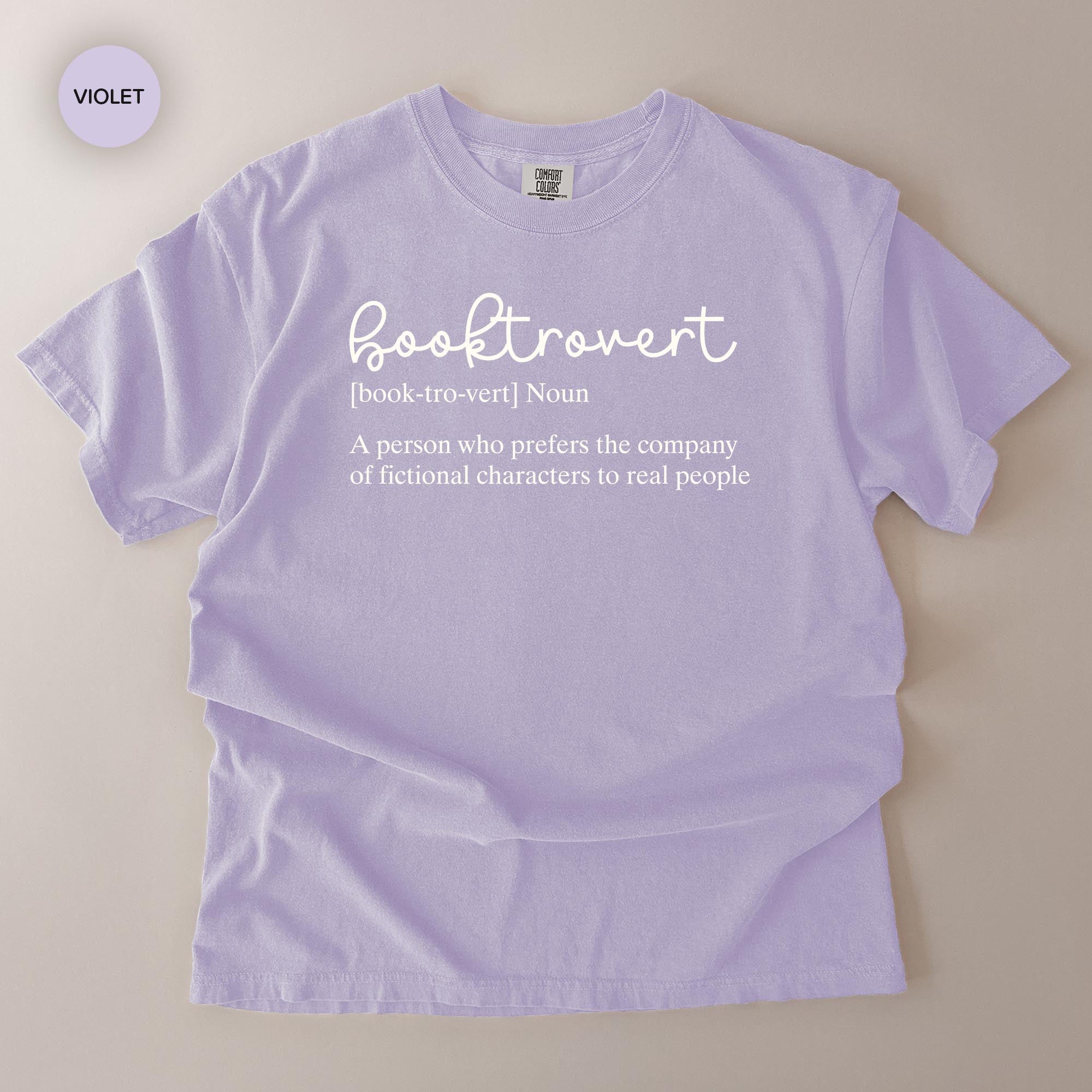 A purple t-shirt with the definition of a book-trov written on it.
