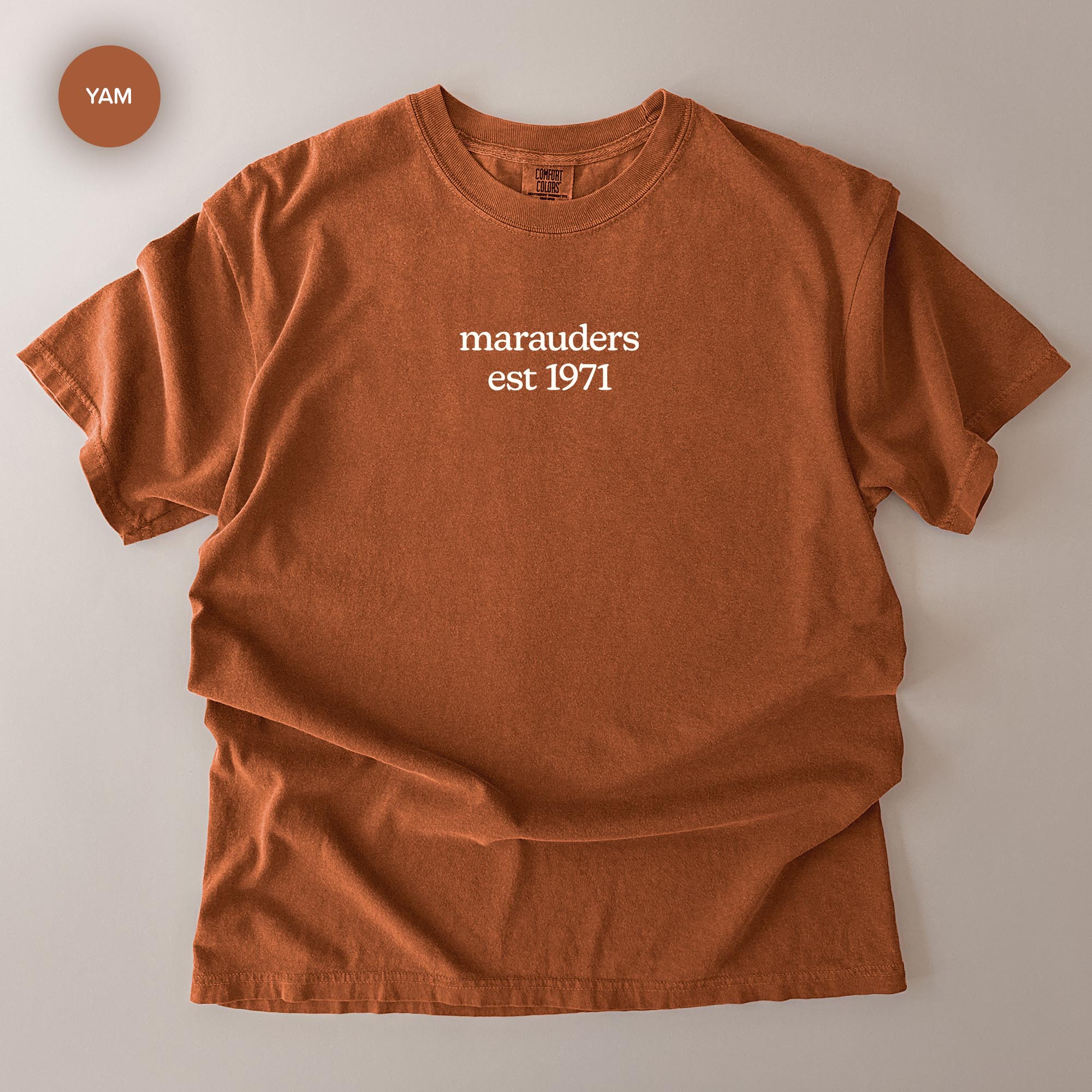 a brown t-shirt with the text "marauders est 1971" printed on it.