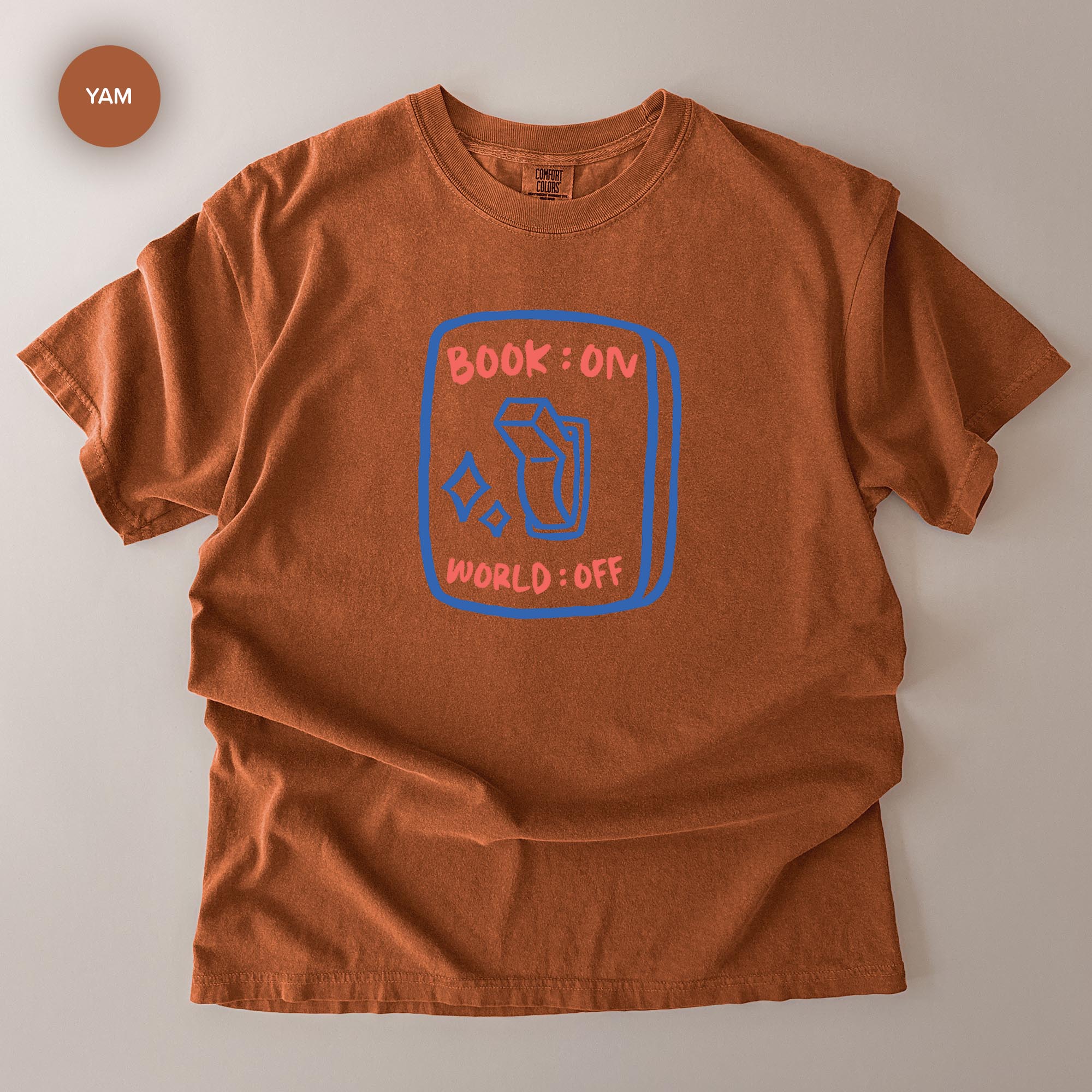 a brown t-shirt with a graphic design on it, which appears to be a book-related design.
