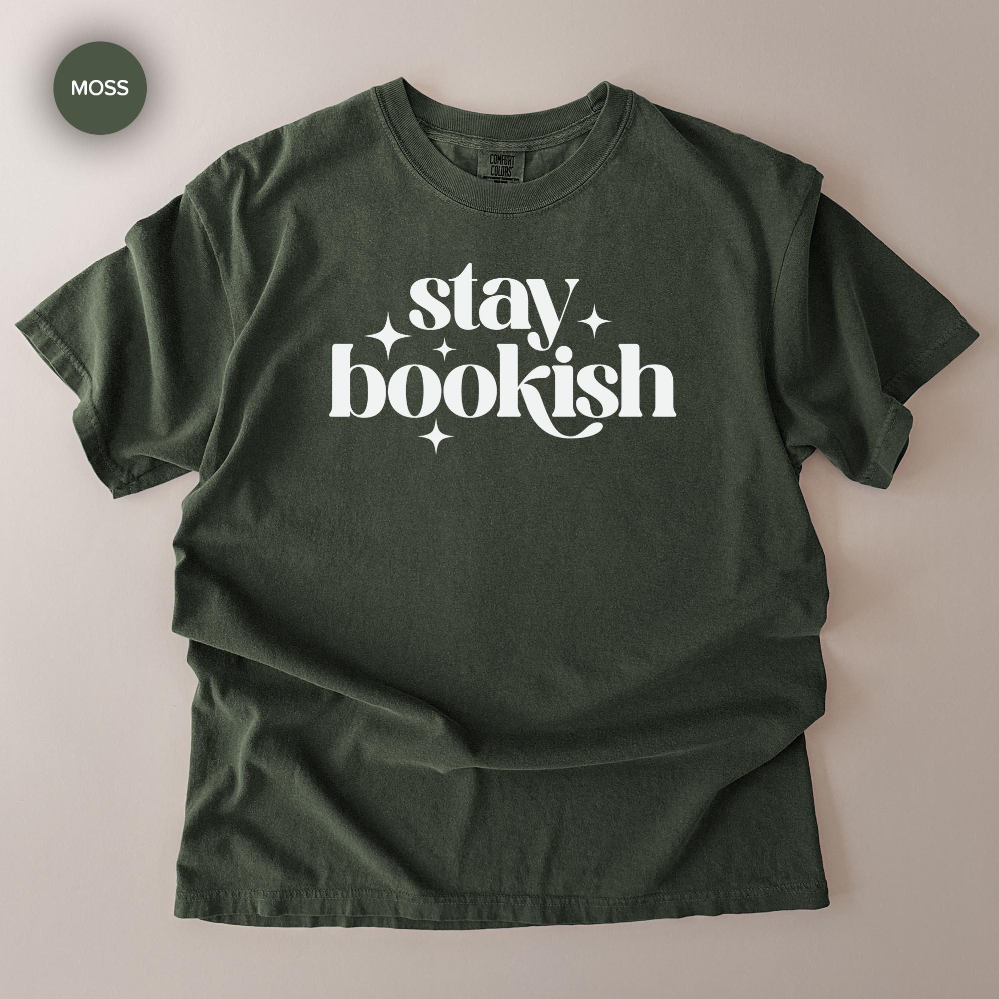 A dark green t-shirt with the text "stay bookish" printed on it in white lettering.