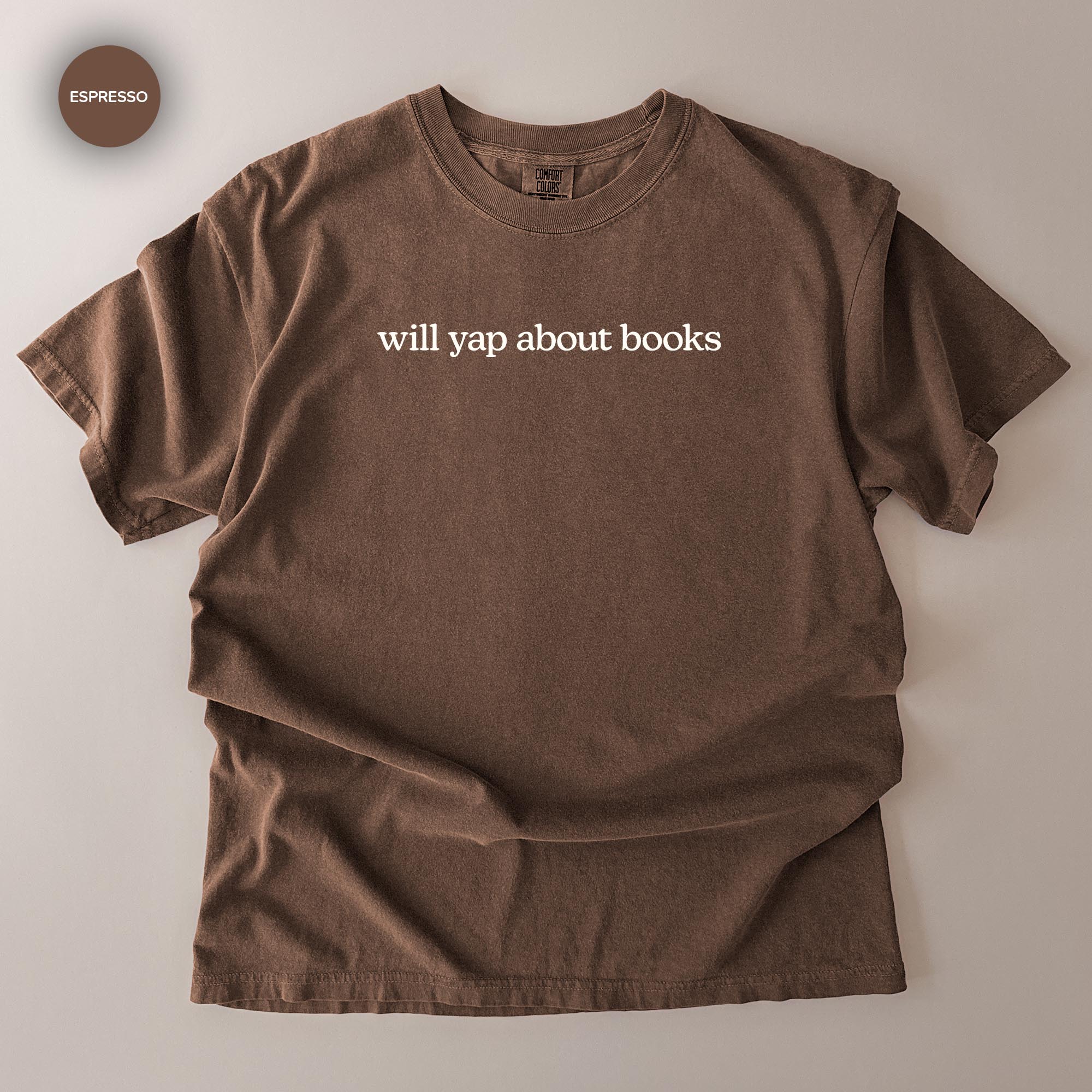 A brown t-shirt with the text "will yap about books" printed on it.