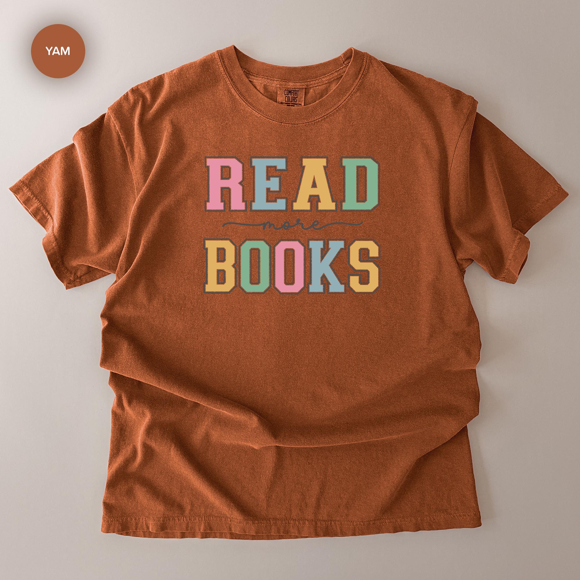 a brown t-shirt with the text "READ MORE BOOKS" printed on it.