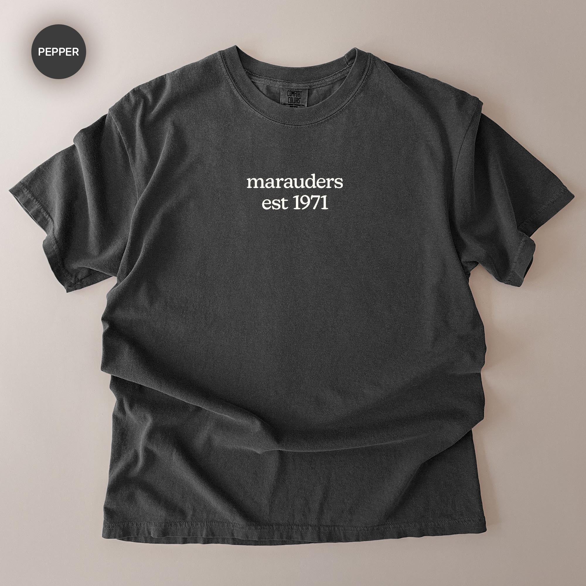 A black t-shirt with the text "marauders est 1971" printed on it.