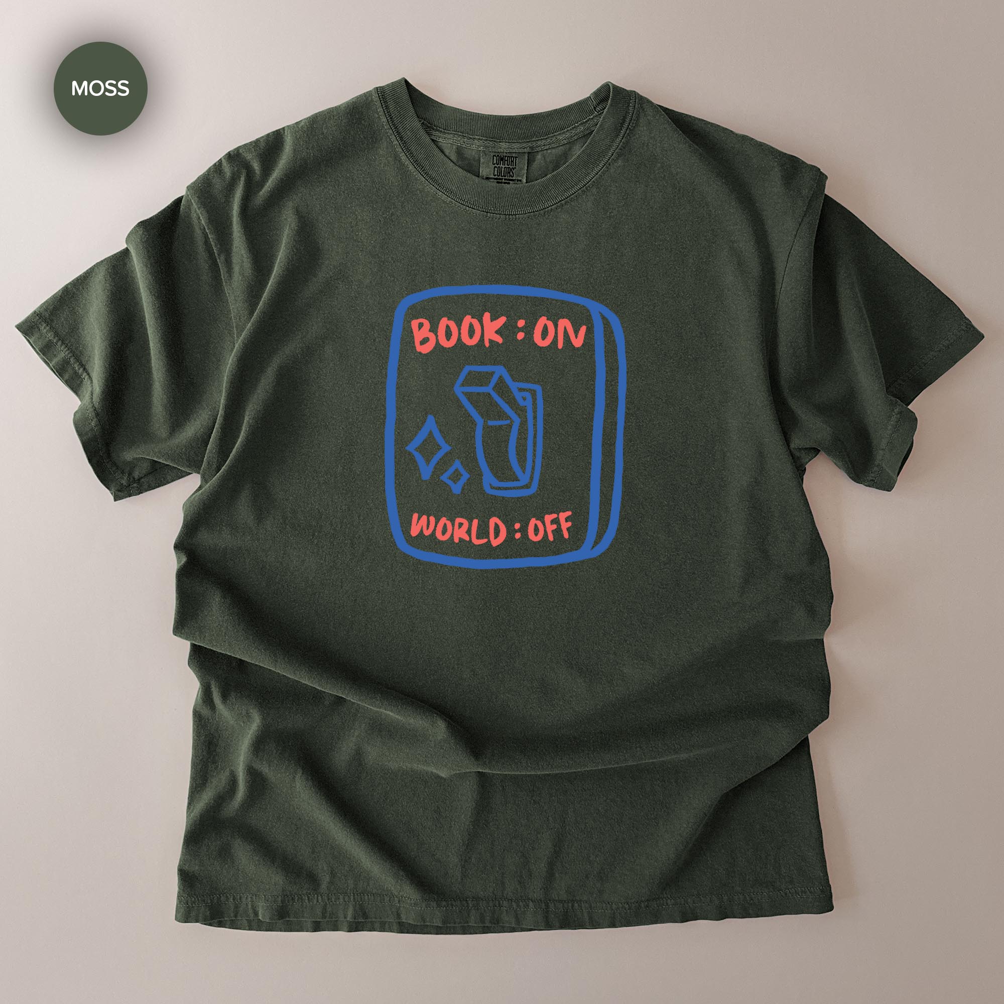 A green t-shirt with a graphic design on it, featuring a book icon and the text "BOOK ON WORLD OFF" printed on it.
