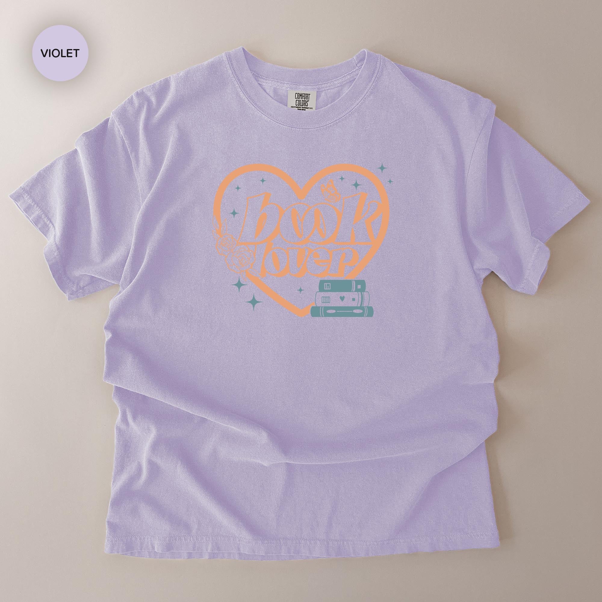 A purple t-shirt with a heart-shaped graphic and text printed on it.