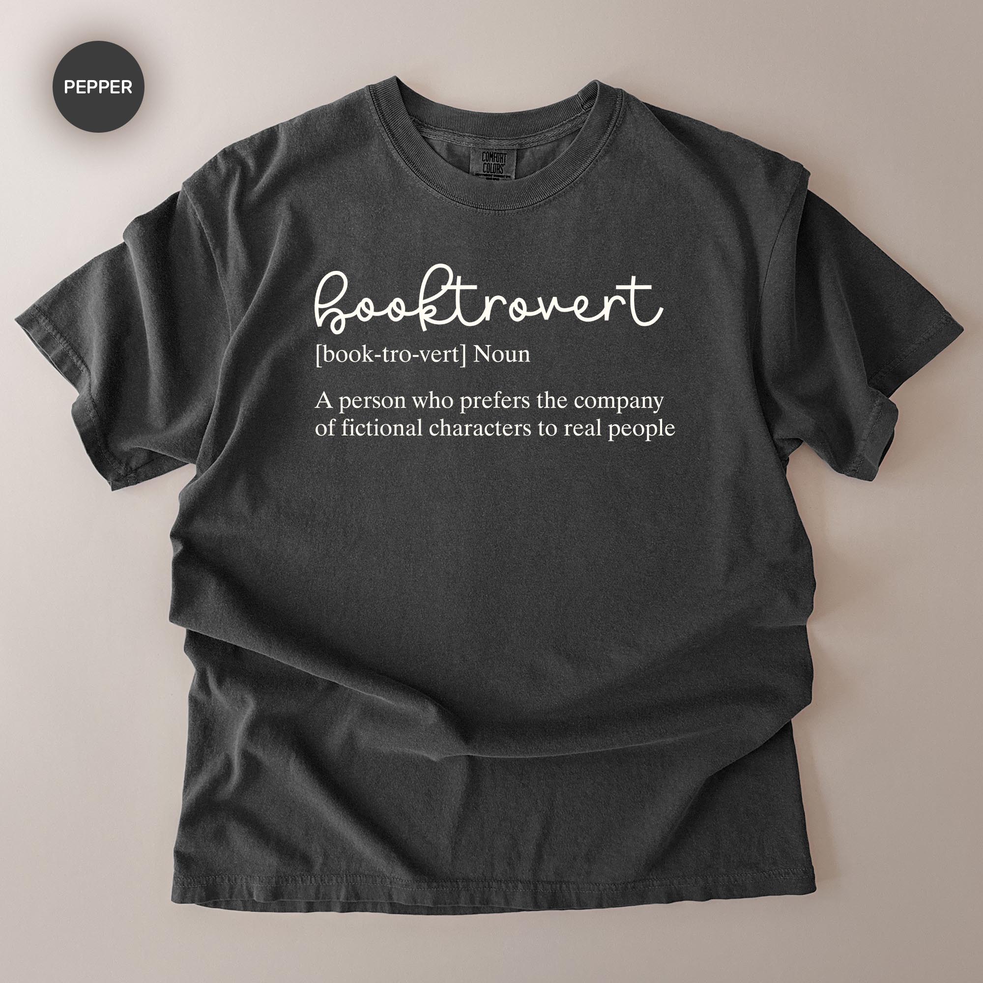 A gray t-shirt with the definition of a book-hoarder printed on it.